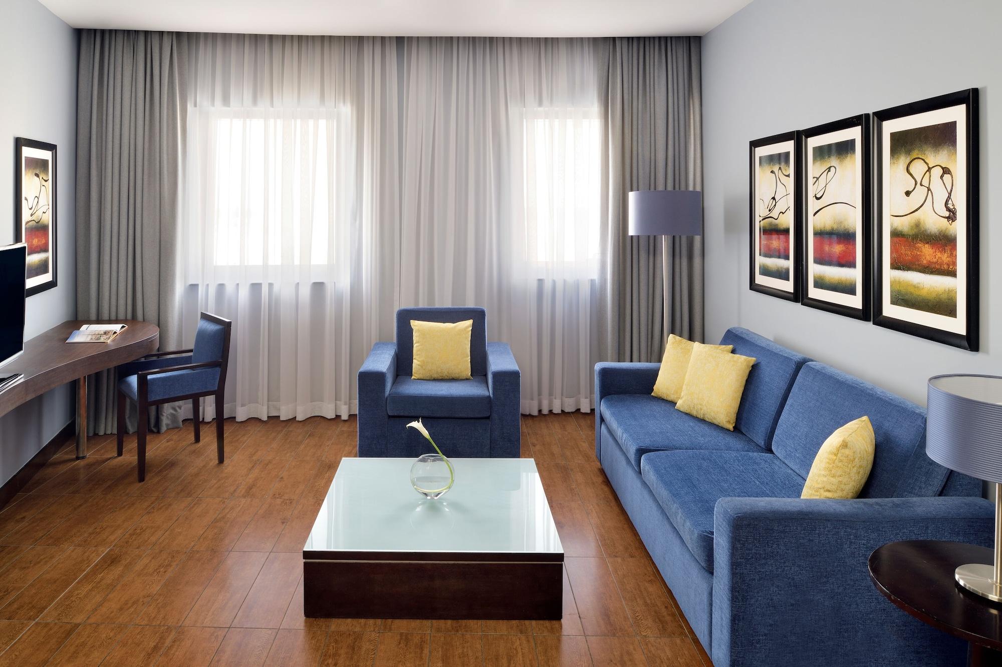 Mövenpick Hotel Apartments Al Mamzar Dubai Exterior foto A living room with a sofa